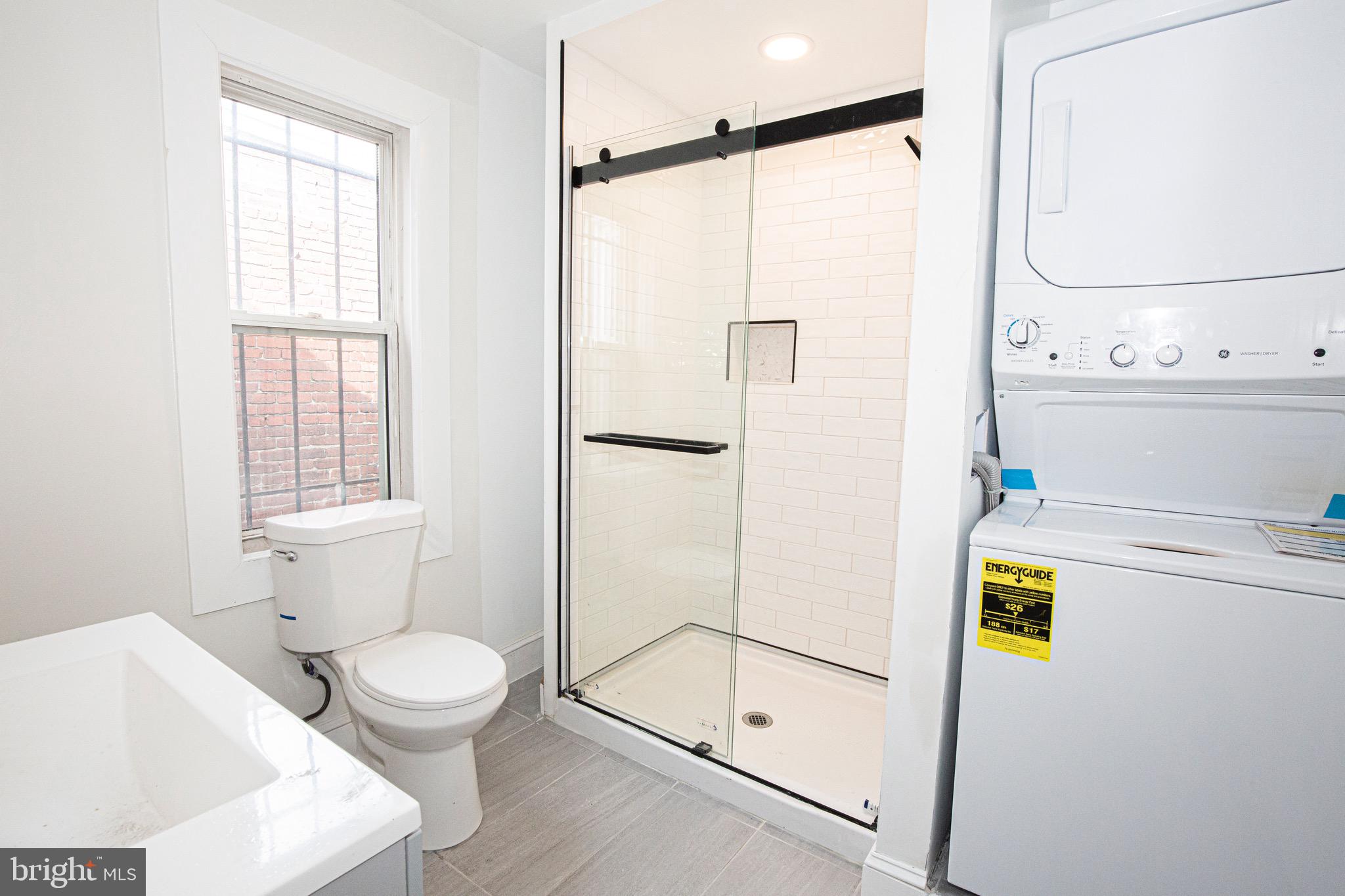 2617 13th Street Northwest Washington, DC 20009 - Photo 9 of 13 a bathroom with a shower a toilet and a window