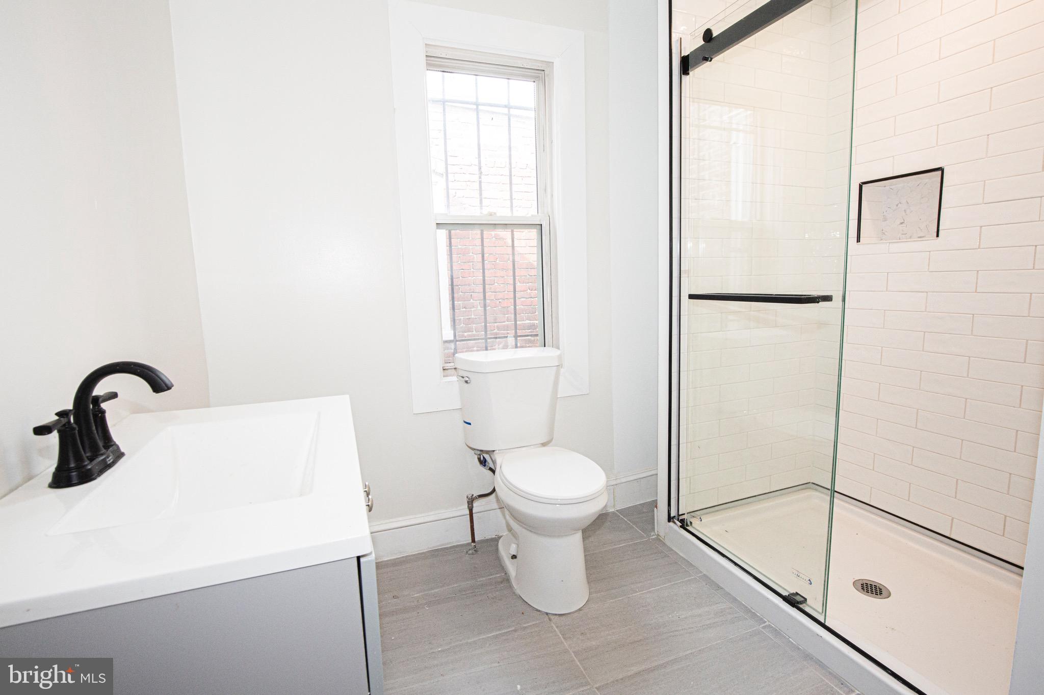 2617 13th Street Northwest Washington, DC 20009 - Photo 10 of 13 a bathroom with a sink a toilet and a shower