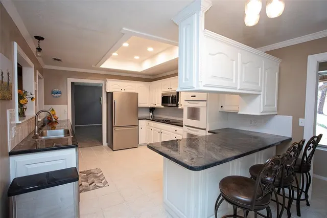 a kitchen with refrigerator and cabinets