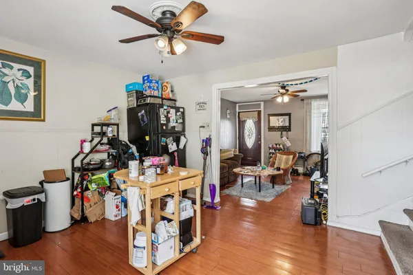a living room filled with furniture and a wooden floor