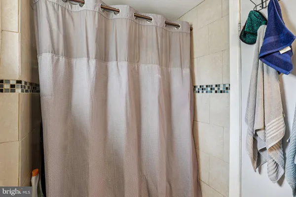 a bathroom with a shower curtain and a curtain