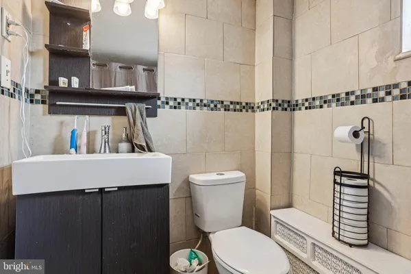 a bathroom with a sink a toilet and mirror