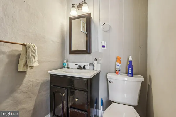 a bathroom with a sink toilet and a mirror