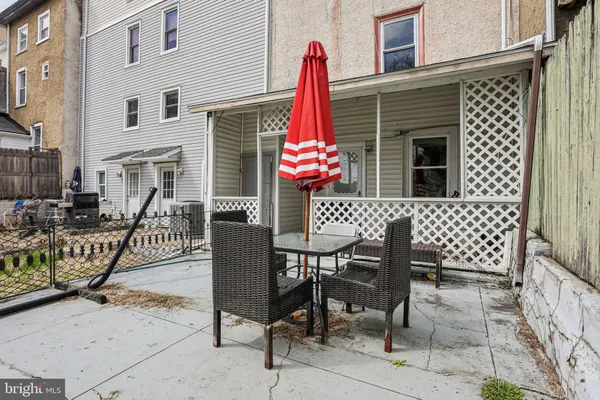 a view of a backyard with table and chairs
