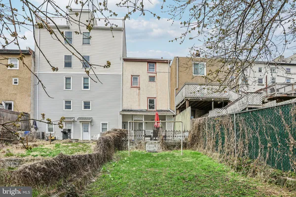 a view of backyard of house with green space