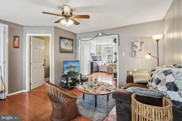 a living room with furniture a chandelier and a window