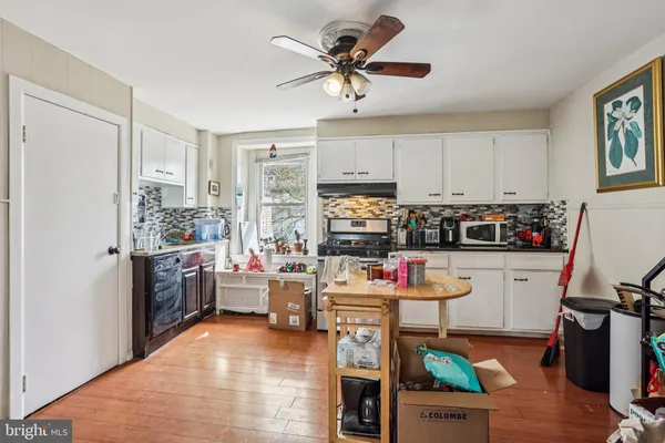 a kitchen with a refrigerator and a stove top oven