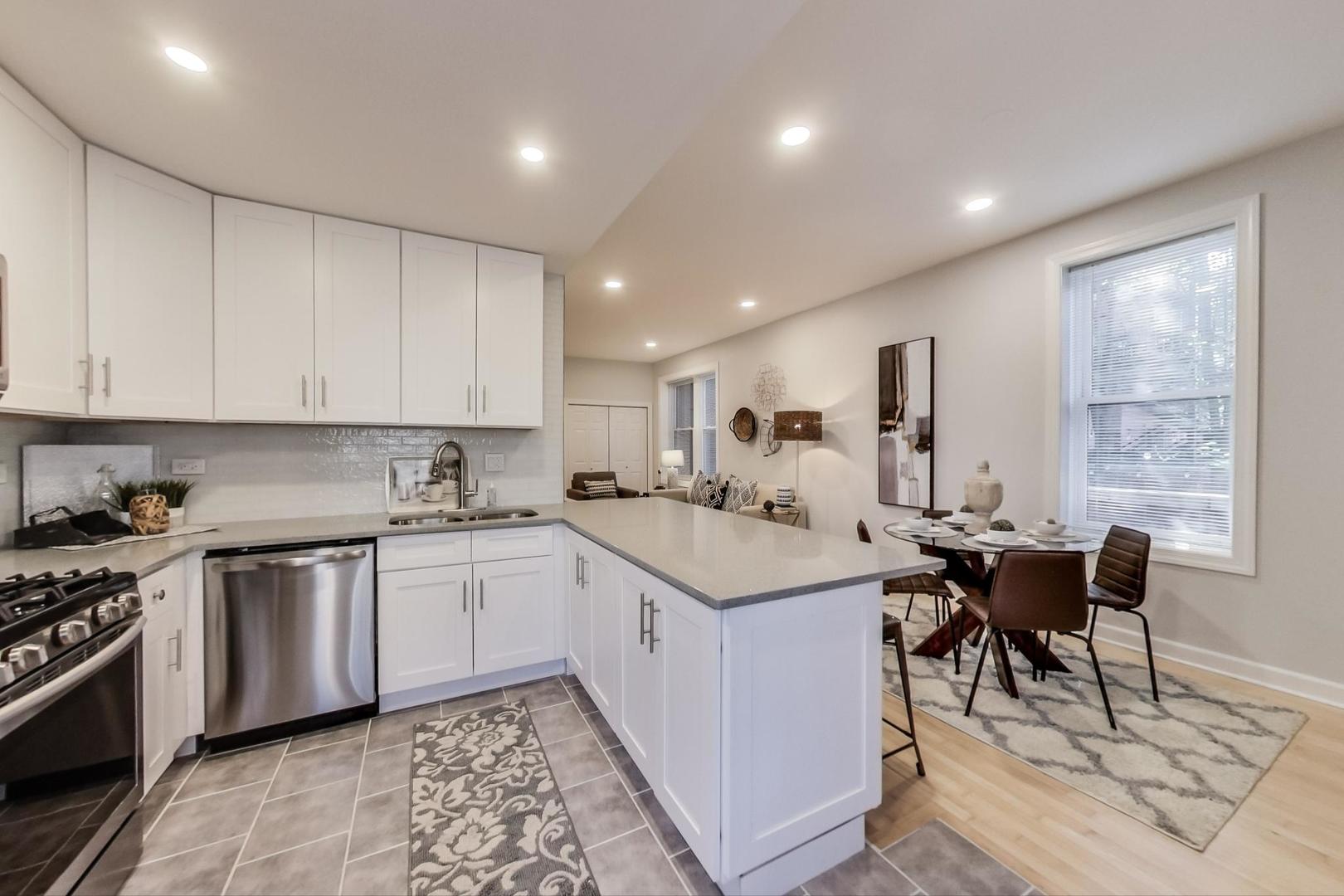 1422 West Lexington Street, Unit 2F Chicago, IL 60607 - Photo 10 of 19 a kitchen with sink cabinets and dining table chair
