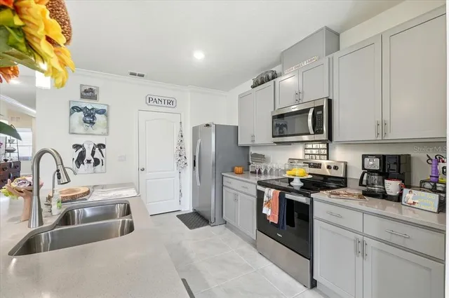 a kitchen with stainless steel appliances granite countertop a refrigerator and a sink