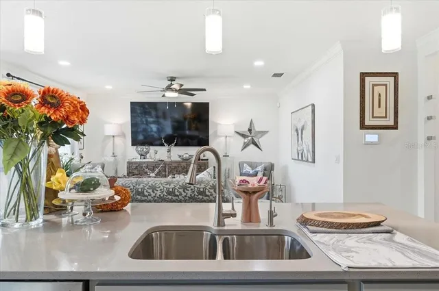 a kitchen with a sink a counter and cabinets
