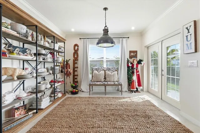 a spacious bedroom with a bed a couch and a flat tv screen on dresser