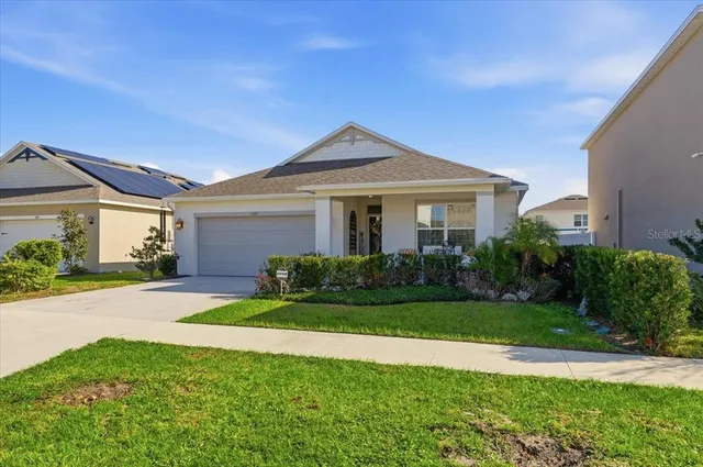 a front view of a house with a yard and garage