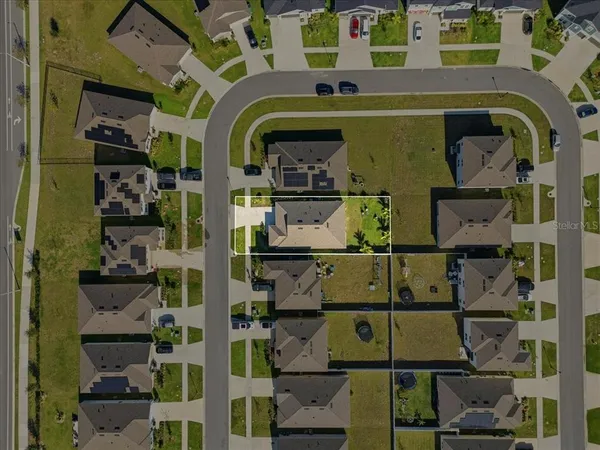 an aerial view of a house with a swimming pool