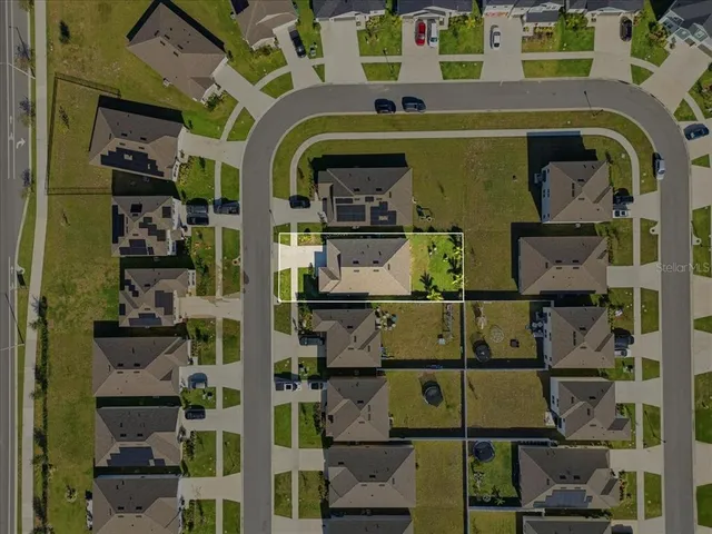 an aerial view of a house with a swimming pool