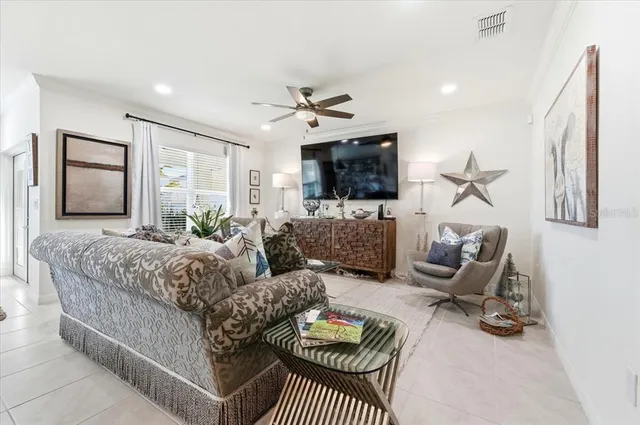 a living room with furniture a flat screen tv and a couch