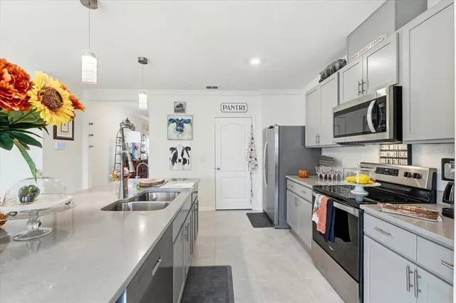 a kitchen with stainless steel appliances a sink a stove and refrigerator