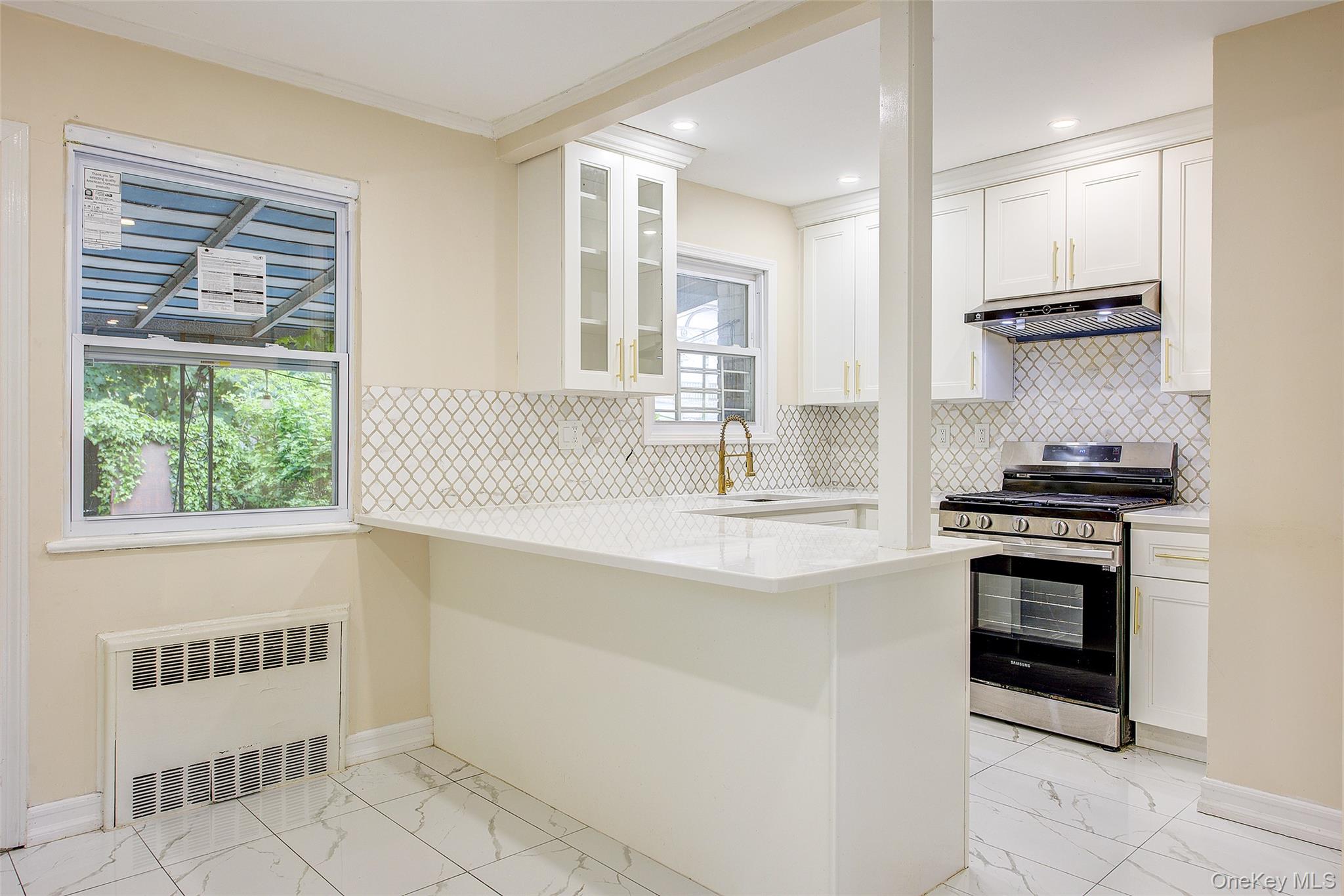 164-38 76th Road Queens, NY 11366 - Photo 8 of 44 a kitchen with stainless steel appliances a stove sink and cabinets