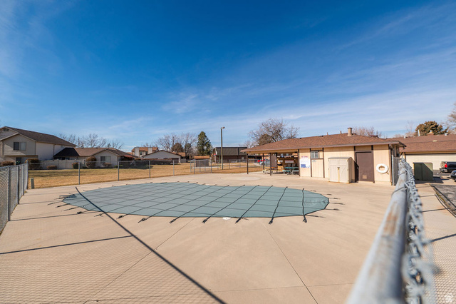 621 Coachman Way Riverdale, UT 84405 - Photo 30 of 38 Community pool featuring a patio and a residential view
