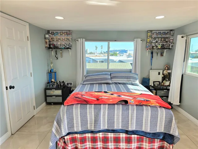 a bedroom with a bed and a large window