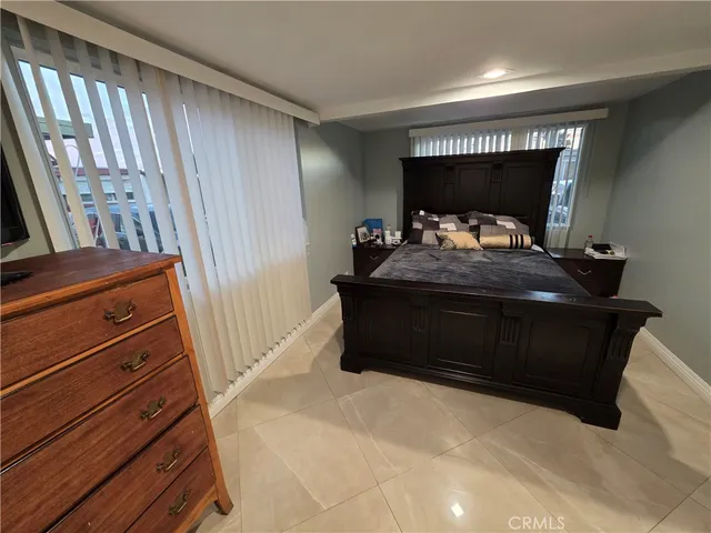 a bed sitting in a room next to a window