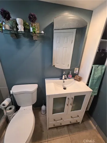 a bathroom with a sink mirror and toilet