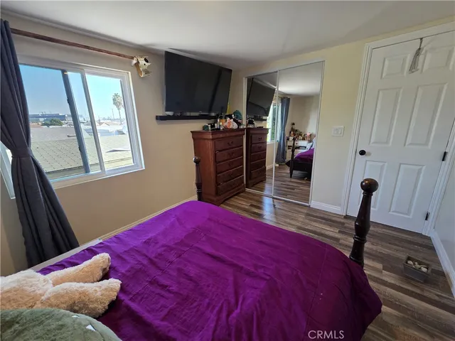 a bedroom with a bed and a flat tv screen