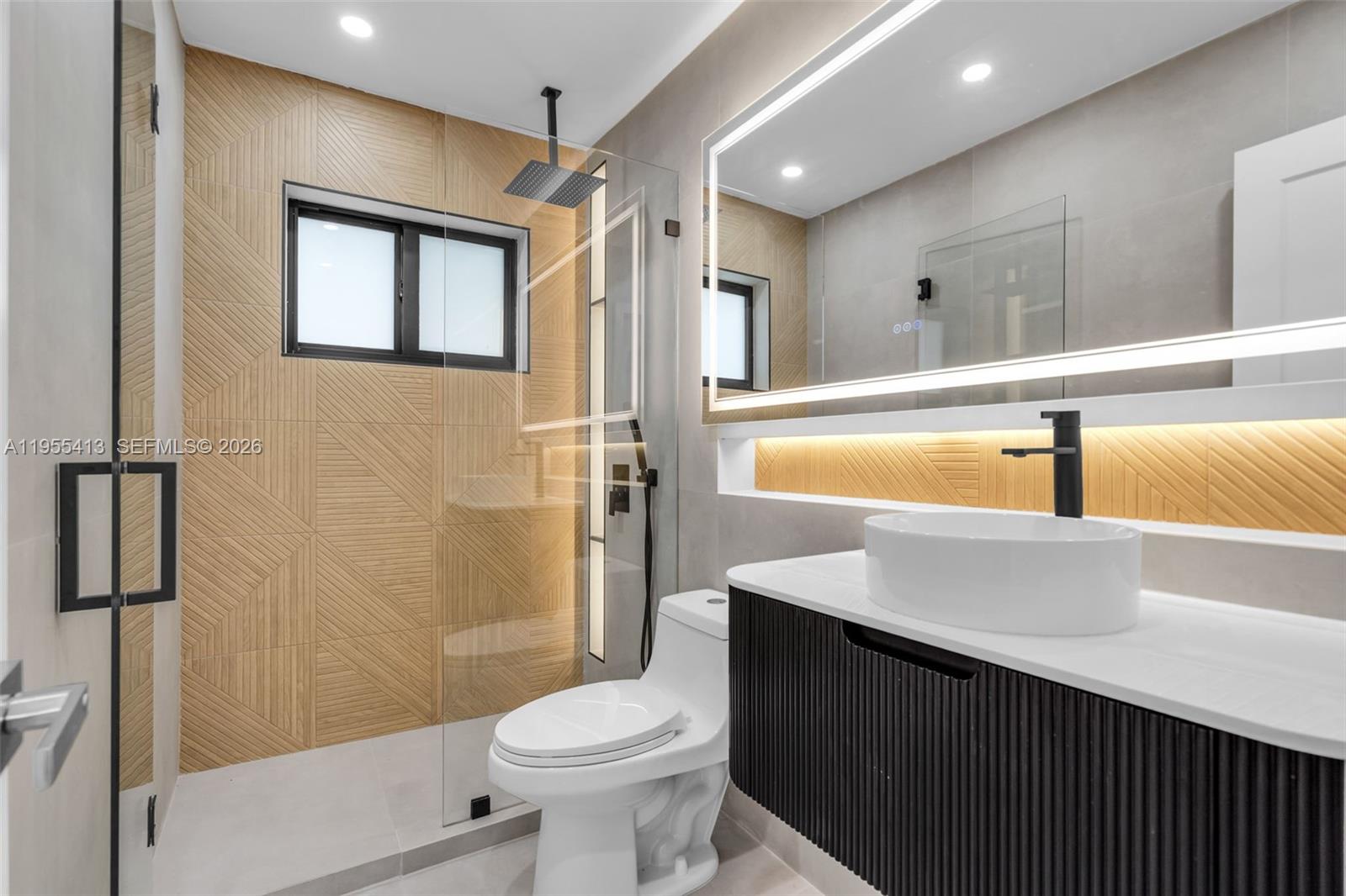 1293 Southwest 22nd Avenue, Unit 1 Miami, FL 33135 - Photo 22 of 28 a bathroom with a sink a toilet and shower