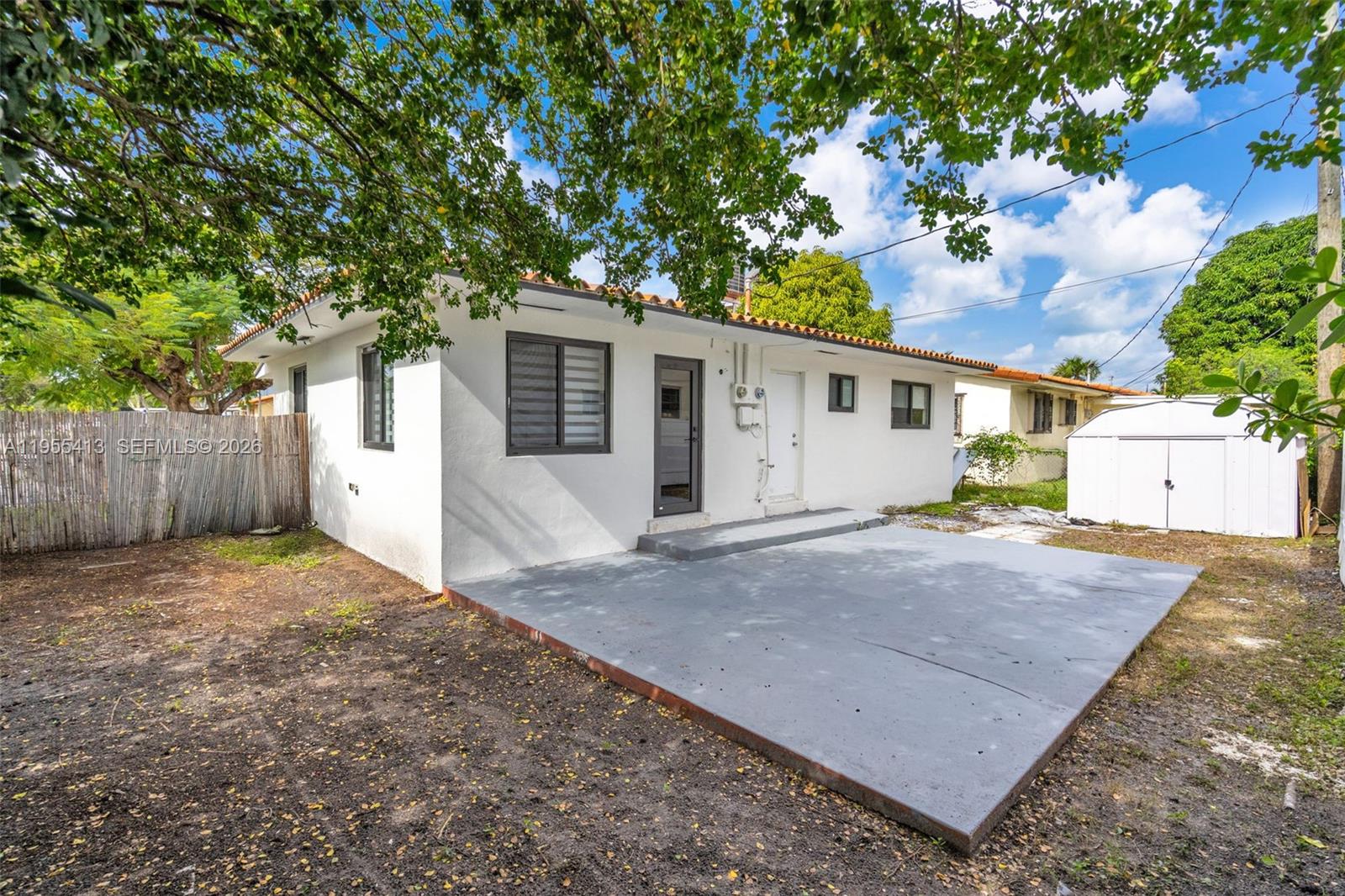 1293 Southwest 22nd Avenue, Unit 1 Miami, FL 33135 - Photo 25 of 28 a front view of a house with a yard and garage