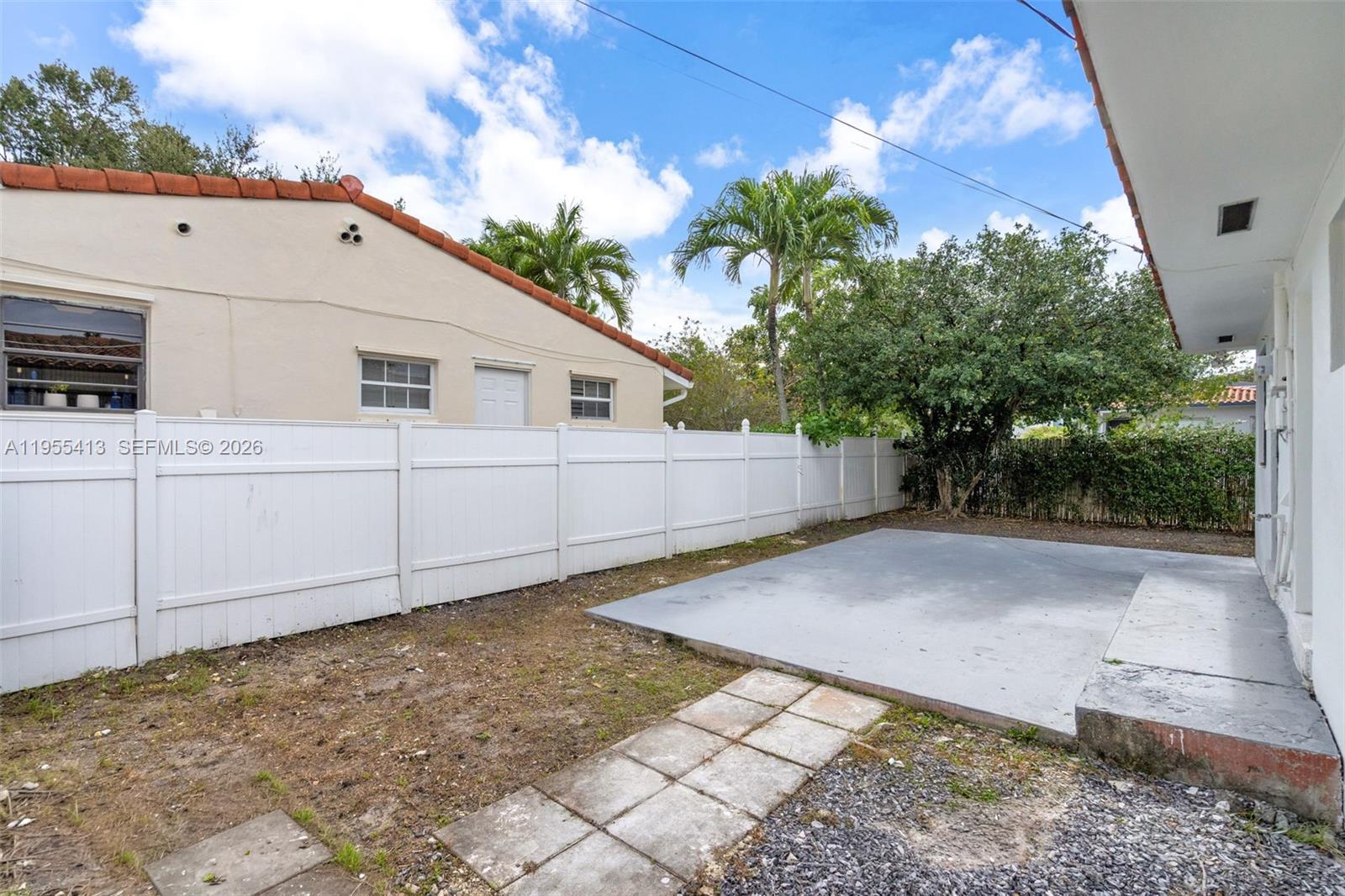 1293 Southwest 22nd Avenue, Unit 1 Miami, FL 33135 - Photo 26 of 28 a view of a white house with a yard and garage