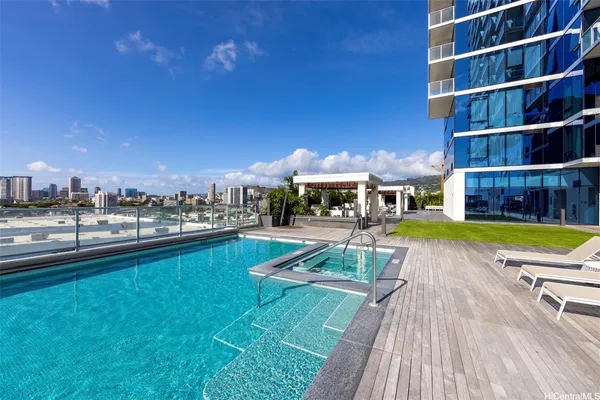 a view of a house with swimming pool and sitting area