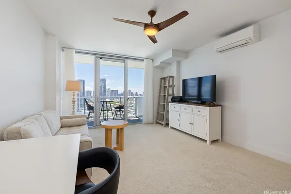 a living room with furniture and a flat screen tv