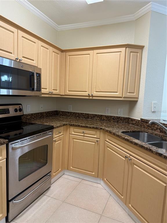 3725 Conroy Road, Unit 2127 Orlando, FL 32839 - Photo 10 of 30 a kitchen with granite countertop white cabinets stainless steel appliances and a sink