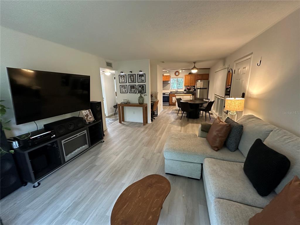 507 Northwest 39th Road, Unit 208 Gainesville, FL 32607 - Photo 9 of 24 a living room with furniture and a flat screen tv