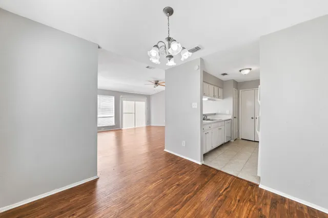 a view of a kitchen with a dishwasher cabinets and wooden floor