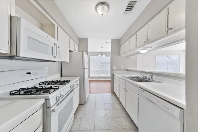 a kitchen with stainless steel appliances a stove sink and cabinets