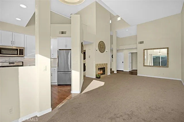 a front view of multi story residential apartment building with yard and green space