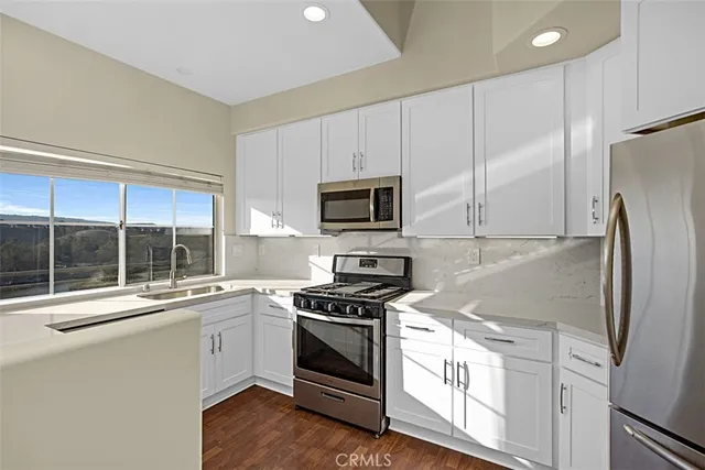 a kitchen with a stove a sink and a microwave