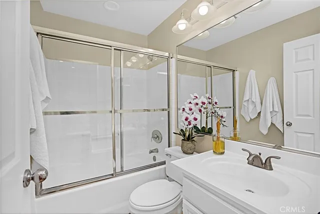 an aerial view of residential houses with outdoor space and lake view