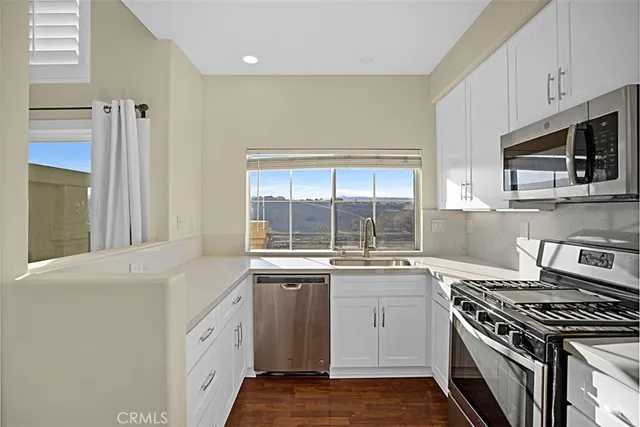 a open kitchen with granite countertop a sink and a window
