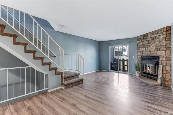 a view of livingroom with wooden floor and fireplace