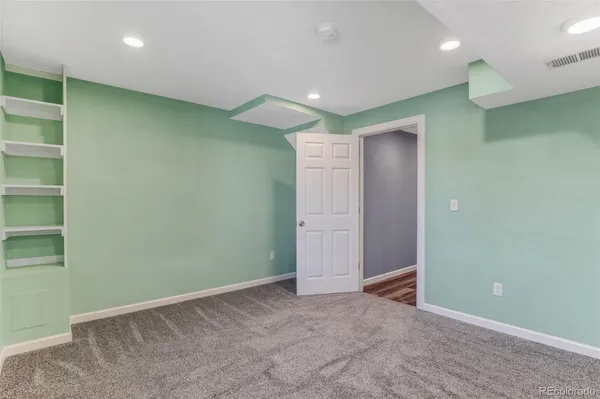 an empty room with a empty space and windows