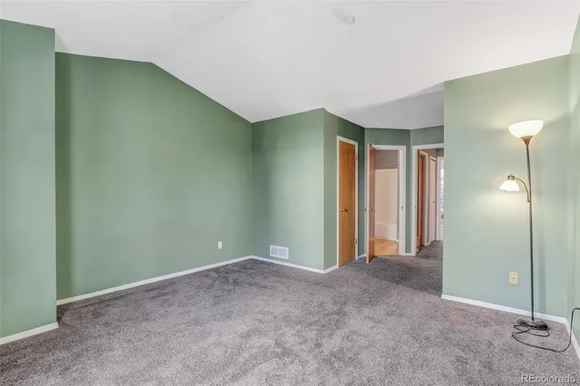 an empty room with closet and a bathroom