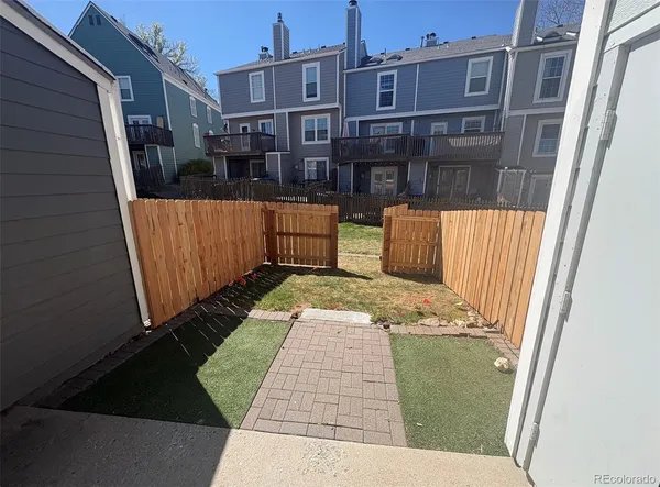 a front view of a house with wooden fence