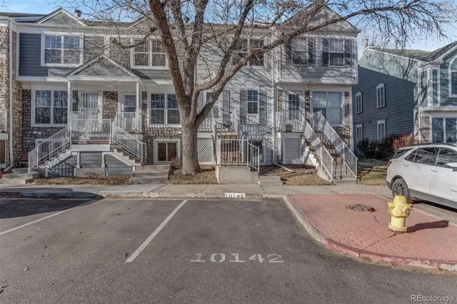 a view of a house with a yard covered in snow
