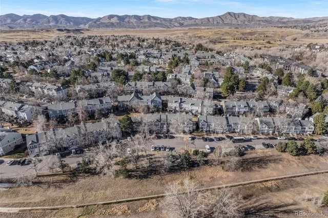an aerial view of a house with a mountain