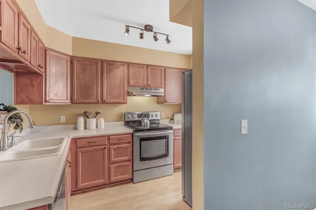 a kitchen with a sink stove and cabinets