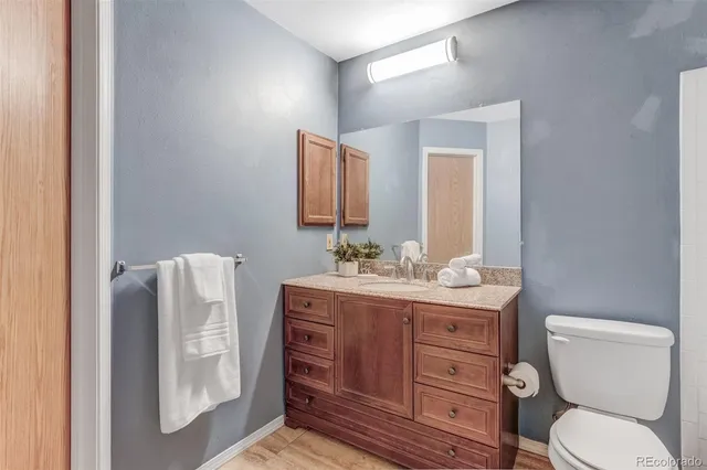 a bathroom with a toilet a sink and mirror