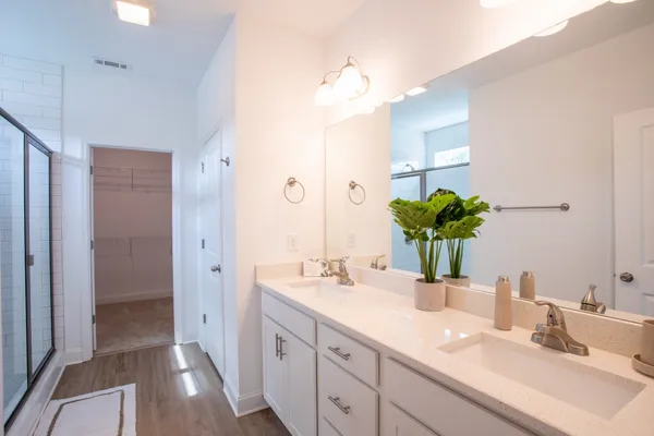 a bathroom with a double vanity sink and a mirror