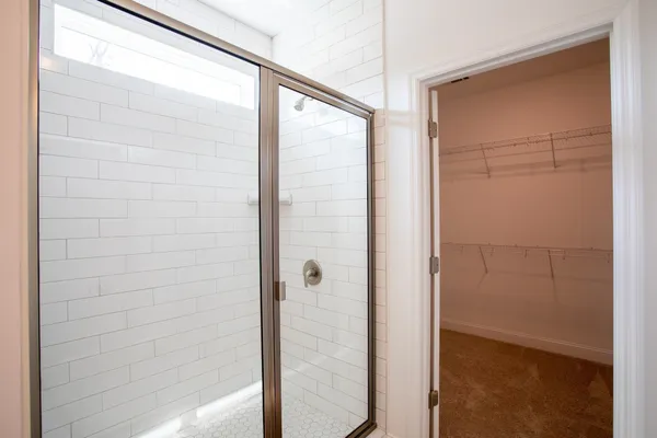 a bathroom with a glass shower door