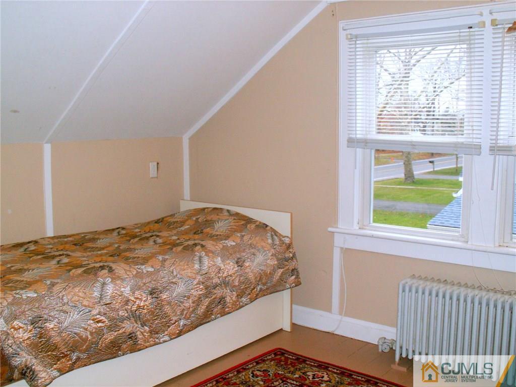 339 Plainsboro Road Plainsboro, NJ 08536 - Photo 13 of 16 a bedroom with a bed and a window